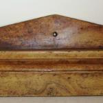 Grain Painted Wall Shelf
New England, Circa 1830 - 40

Very unusual mustard grain painted wall shelf
Length 36 3/4"  Height 11" to top of peak