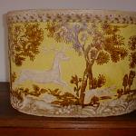 Wallpaper Covered Hat Box, decorated with Stag Hunt scene on a yellow ground. Circa 1840 -50