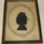 18th Century hollow cut silhoutte of a young woman in an oval pierced border in a contempary frame by Perry Hopf.