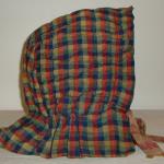 Childs Bonnet - 
New England, 19th Century 
Quilted childs bonnet woven in multi colors.  One small tear in back, otherwise in very good  condition.   